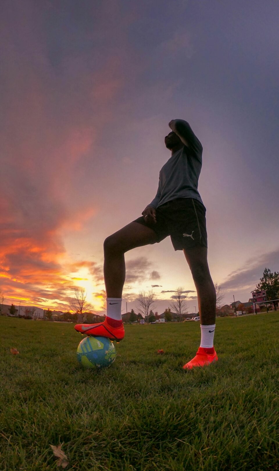 Footballer training at sunset